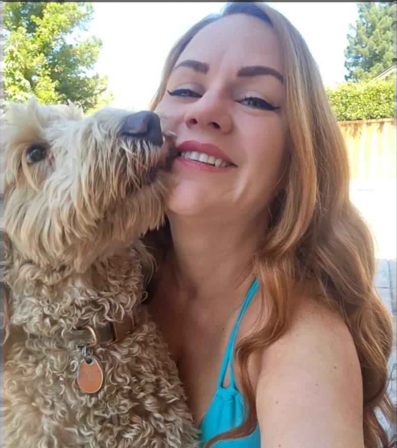 Brittany with a doodle kissing her cheek